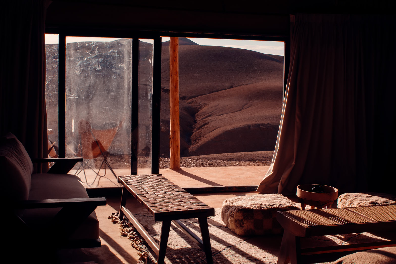 marrakech desert tours: 7 Best Routes and Experiences 2 Rocky Agafay Desert hills and a camp near Marrakech at sunset